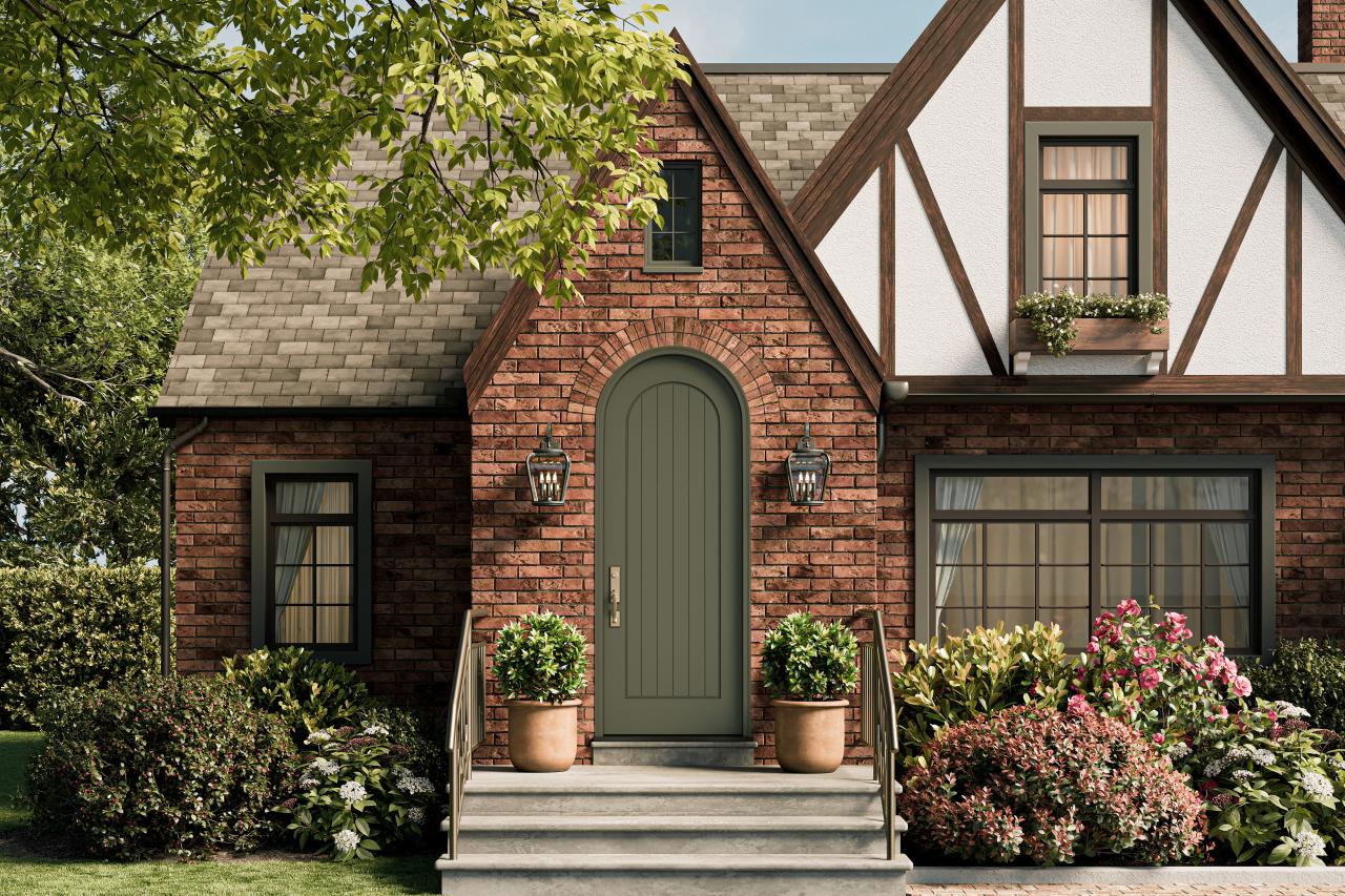 Radius top VG1040-ES401 Resilient Wood Entry System with vertical plank detailing and Multi-Point Lock hardware on a Tudor-inspired brick home.