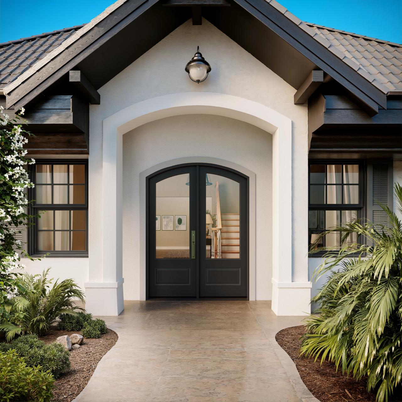 FL112-ES501 Resilient Wood Entry System with Cove & Bead sticking, raised panels, and clear glass, featured in an arched double-door entry on a modern style home