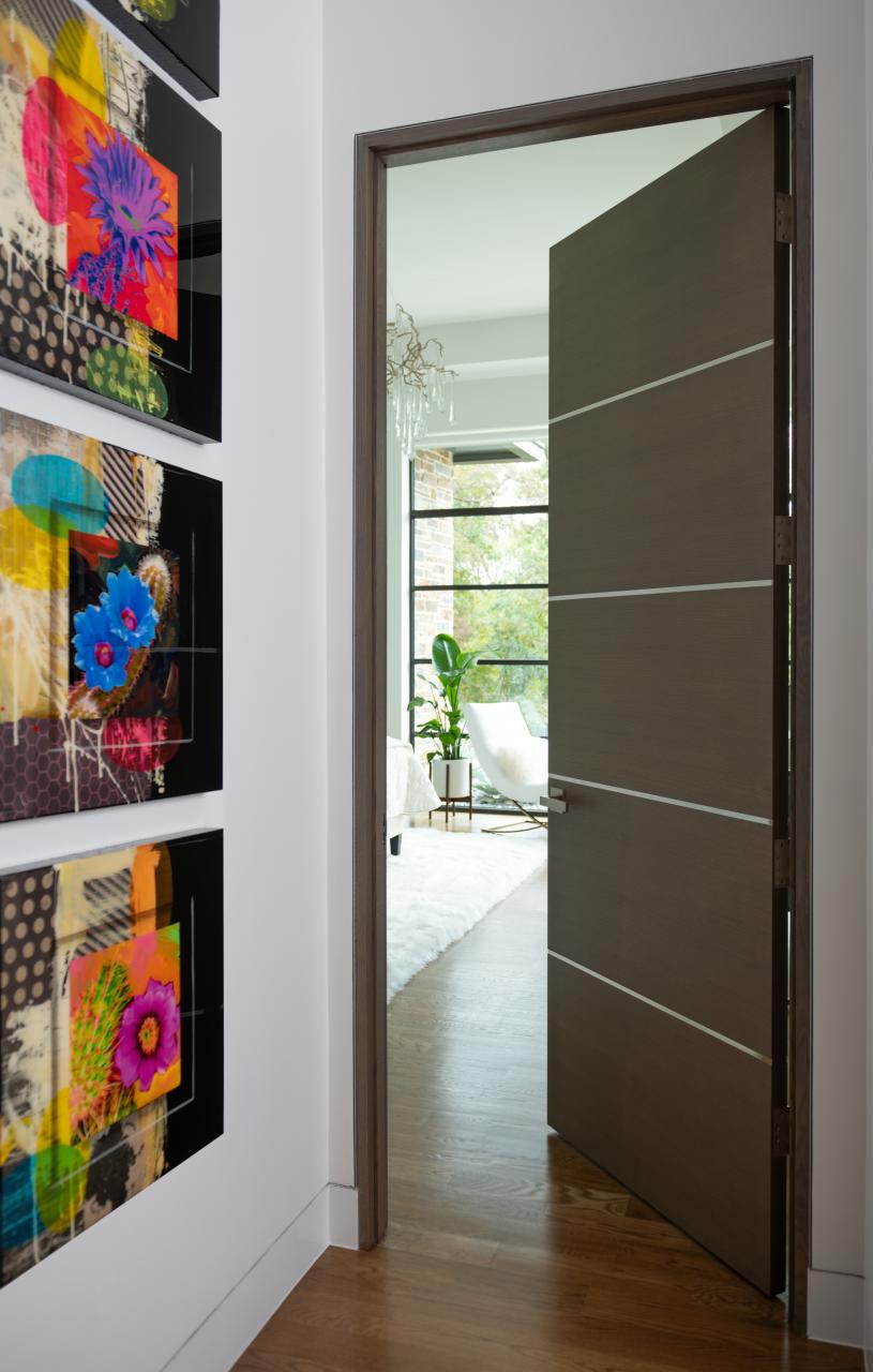 Bedroom featuring a TMIR5000 door in quarter sawn white oak with Grey Mist stain and ½" bright stainless steel inlays.