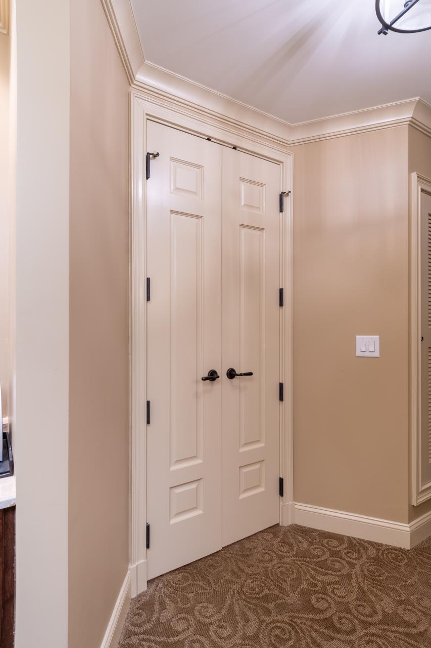 A pair of TS3100 doors in MDF with Roman Ogee sticking and Scoop (B) panel lead to the bathroom suite.