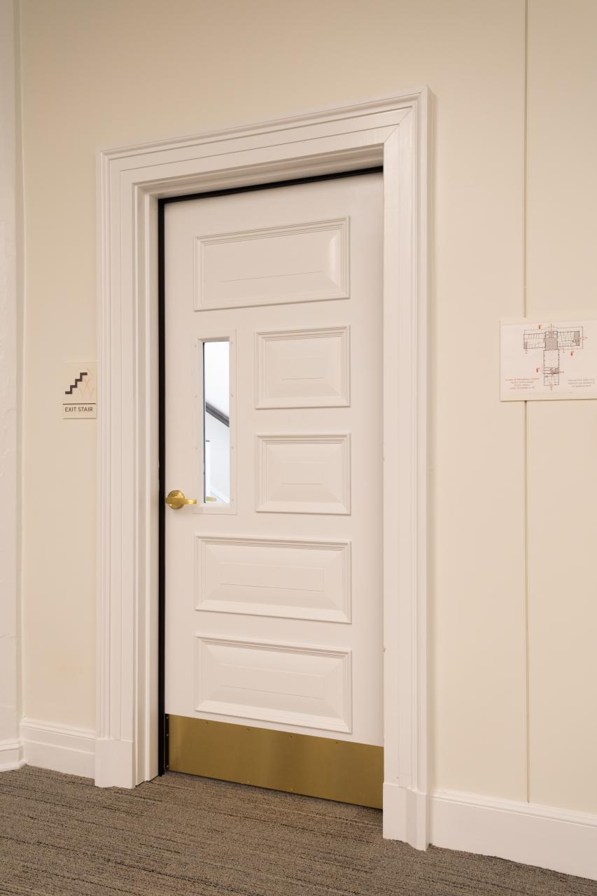 Custom fire-rated door in MDF with fire glass, Bolection (BM) moulding and Senior Raised (E) panel.