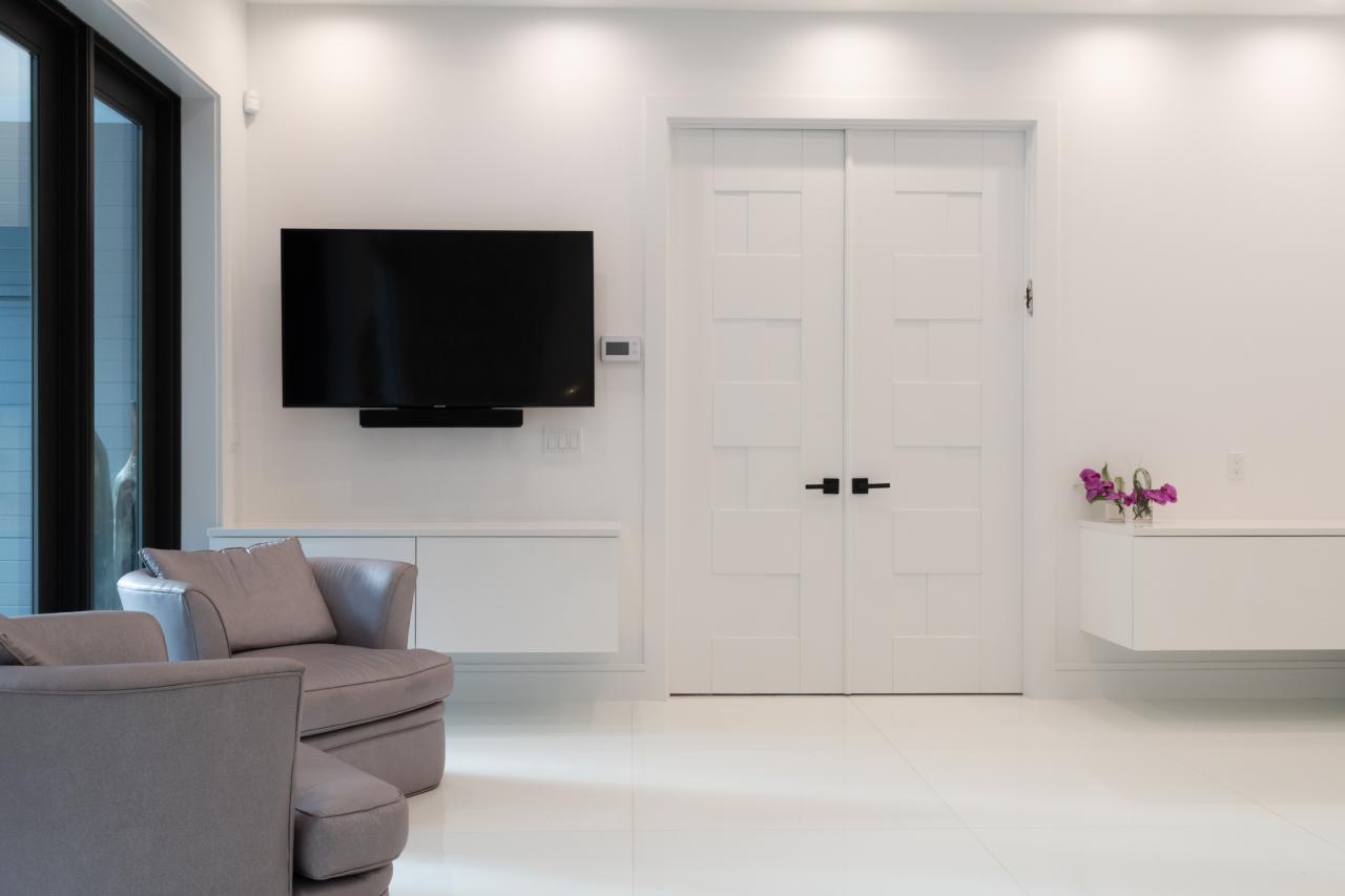 This modern master bedroom features a pair of TM9420 doors in MDF with flat panel inserts.