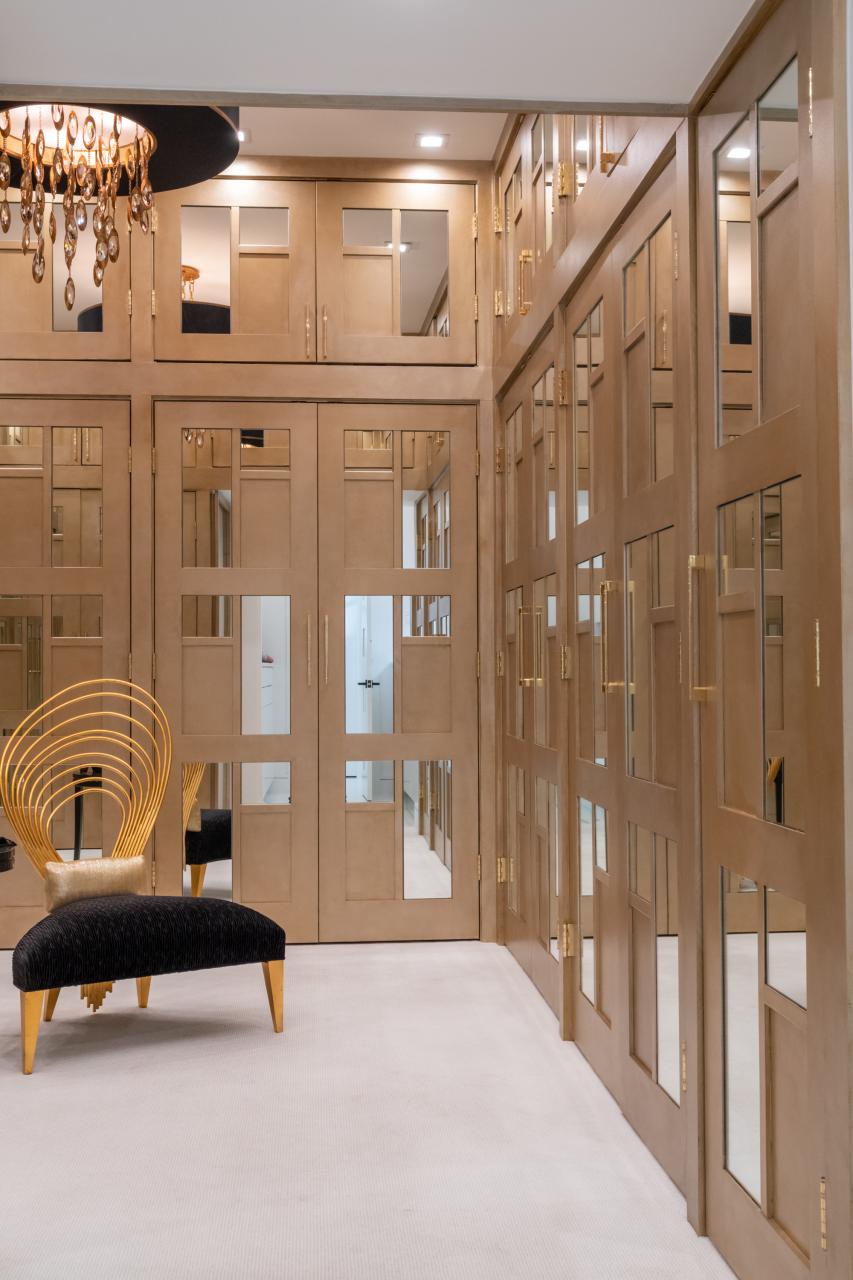 The designer added glamour to this walk-in closet by custom applying plant-ons and mirrors to TS3000 doors in MDF.