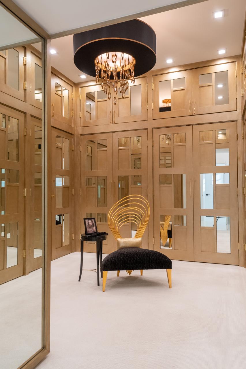 The designer added glamour to this walk-in closet by custom applying plant-ons and mirrors to TS3000 doors in MDF.