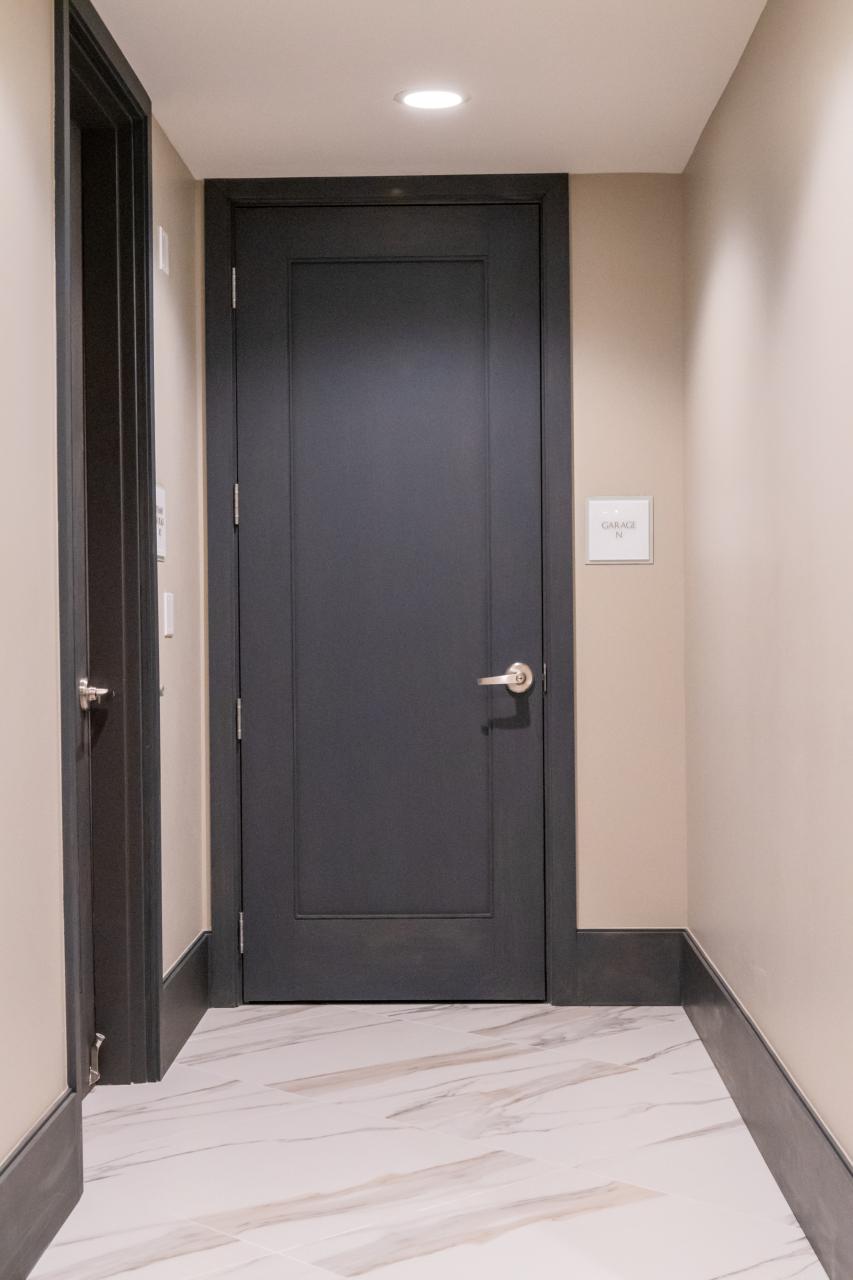 Condominium tower featuring TS1000 doors, in rift sawn white oak with Quirk (QM) moulding and Flat (C) panel in lobby.