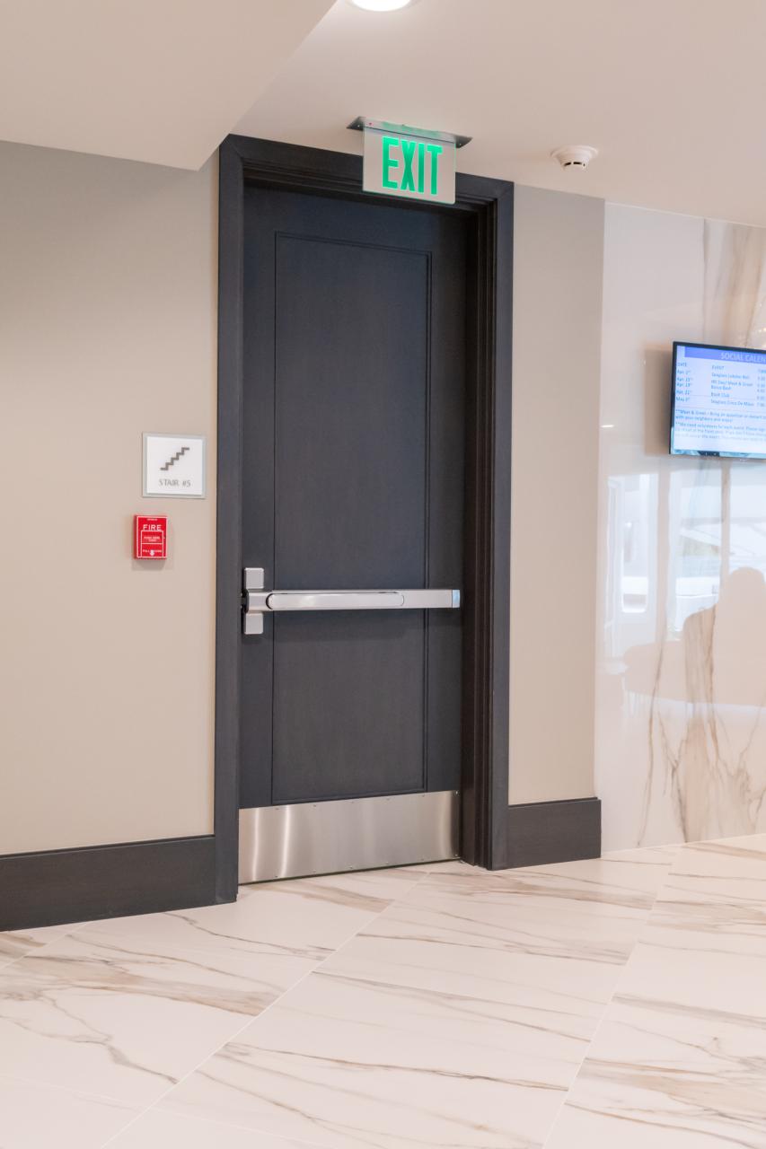 Condominium tower featuring TS1000 doors, in rift sawn white oak with Quirk (QM) moulding and Flat (C) panel in lobby.