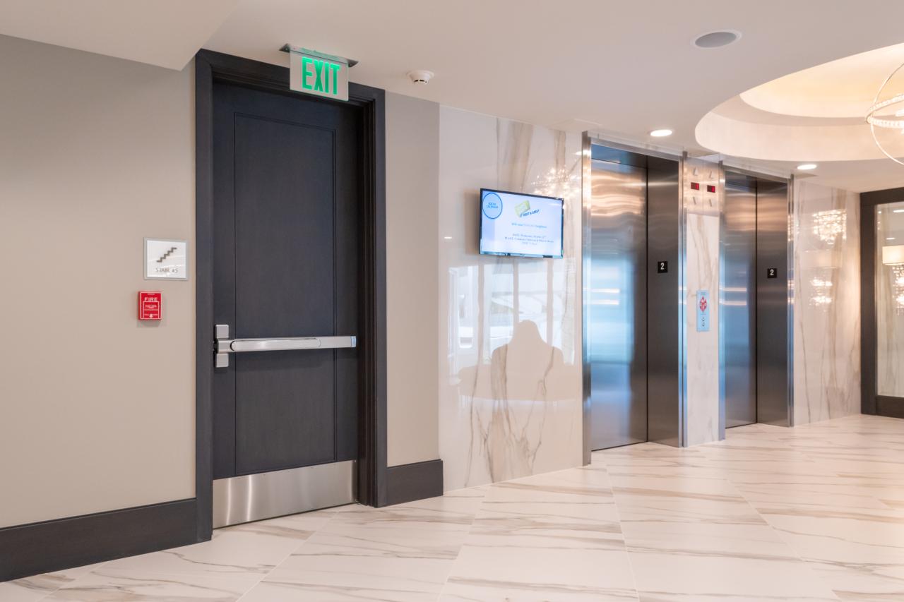 Condominium tower featuring TS1000 doors, in rift sawn white oak with Quirk (QM) moulding and Flat (C) panel in lobby.