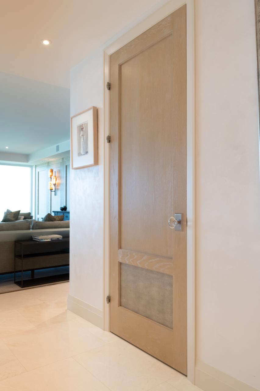 This modified TS2210 door, in wire-brushed plain sawn white oak with customer applied ceruse finish and Shagreen Grey Oyster leather, features olive knuckle hinges.