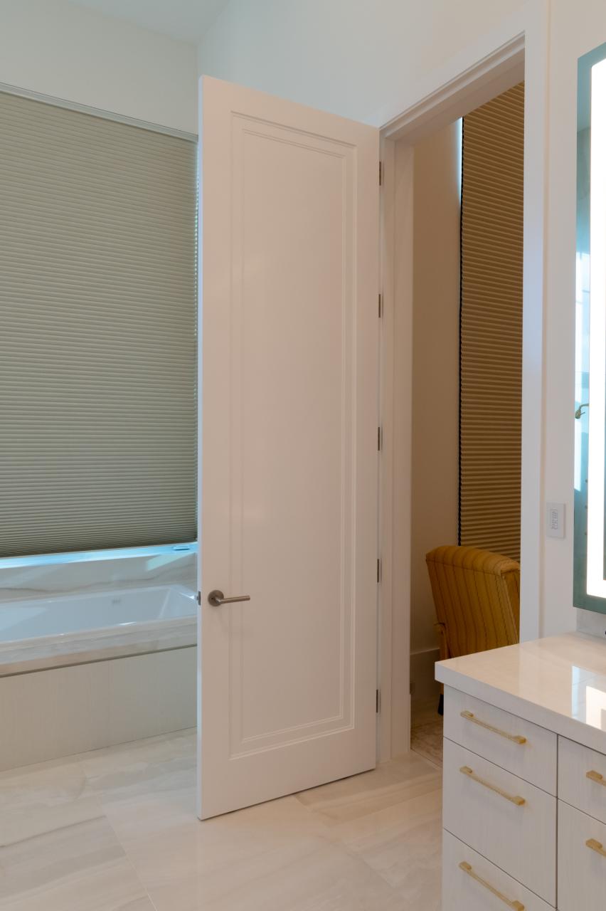 This master bath features monumental 10' tall TS1000 doors in MDF with Miracle (MR) moulding and Flat (C) panel.