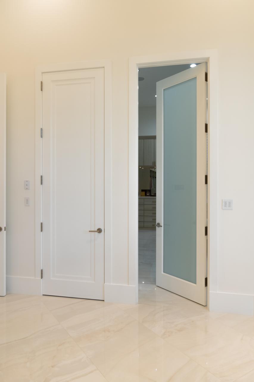 This master bath features 10' tall TS1000 panel doors in MDF with Miracle (MR) moulding and glass doors with One Step sticking and White Lami glass.