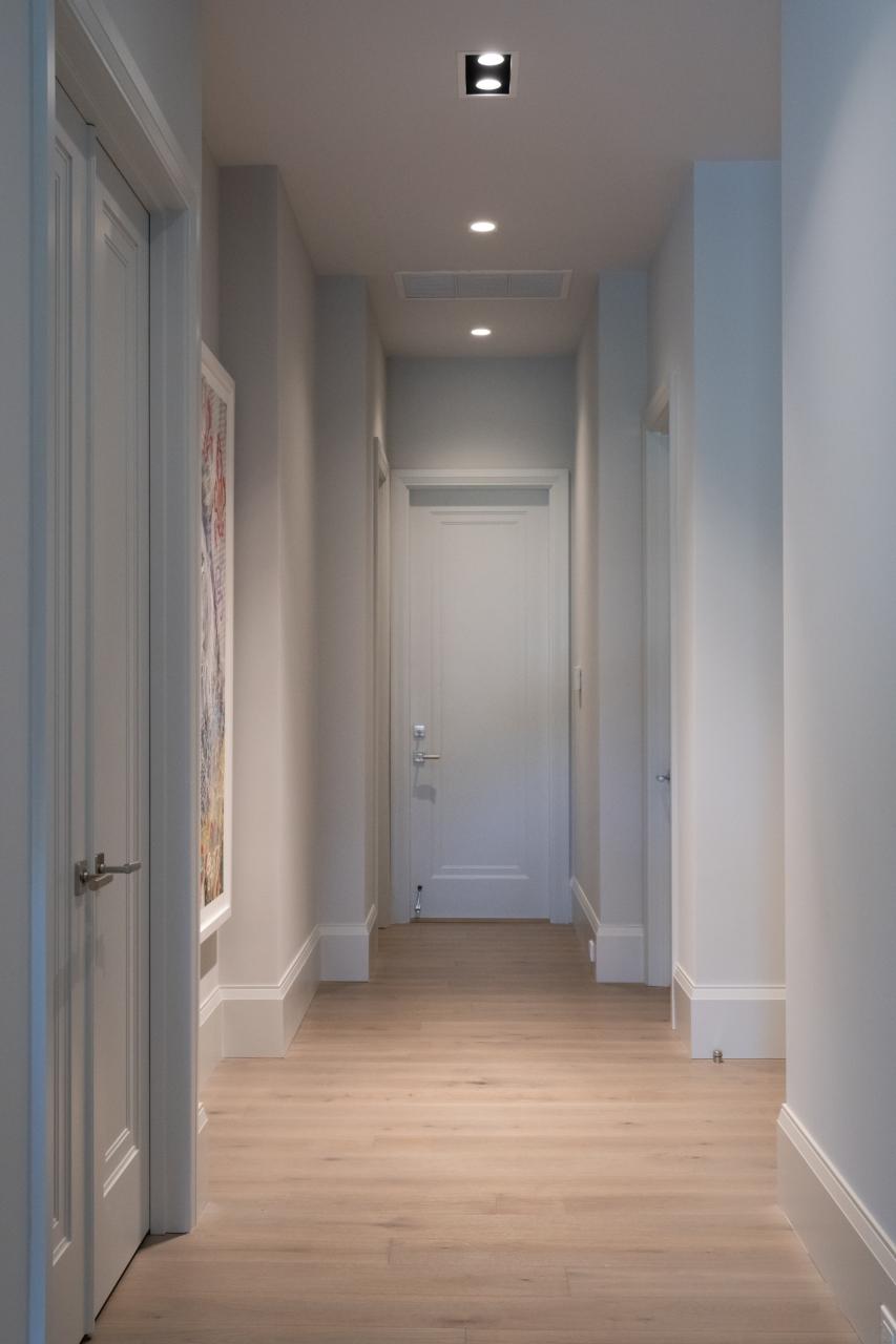 A hallway with TS1000 doors, in MDF with Miracle (MR) moulding and flat (C) panel, leads to the garage.