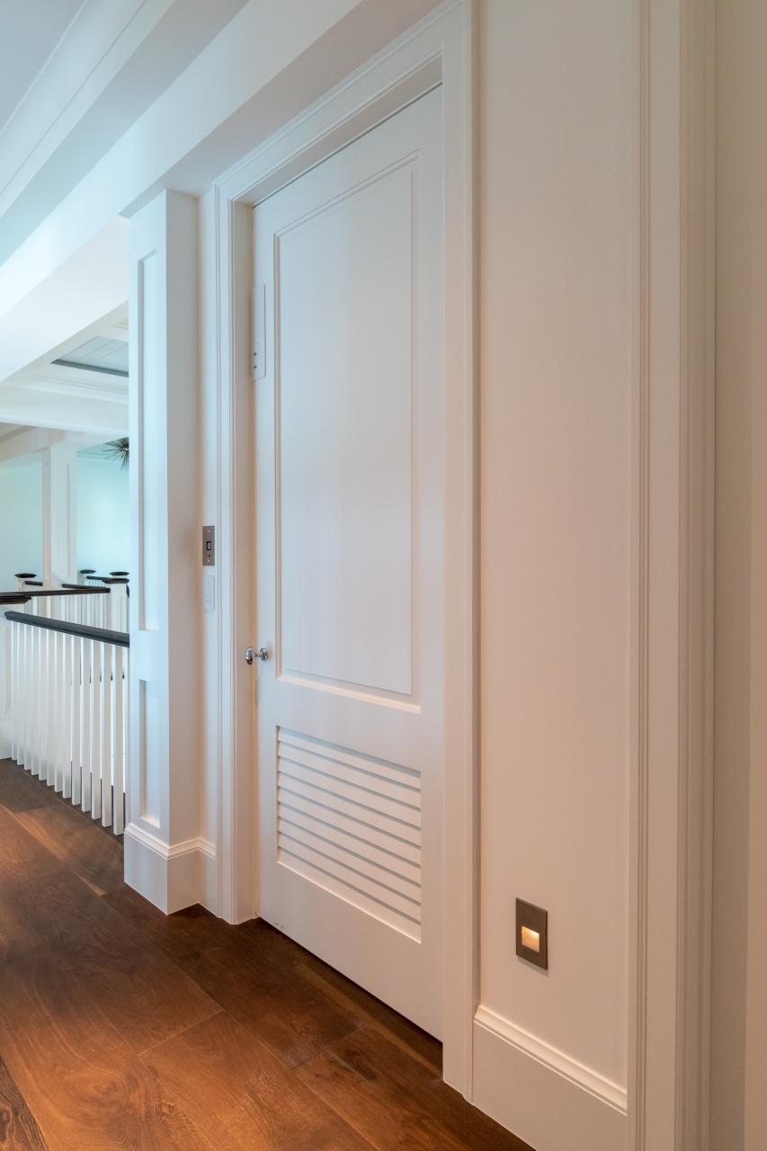 The elevator on this coastal home features a TS2060 in MDF with Roman Ogee (OG) sticking and Raised (A) panel. The bottom panel has been switched to a false louver panel.