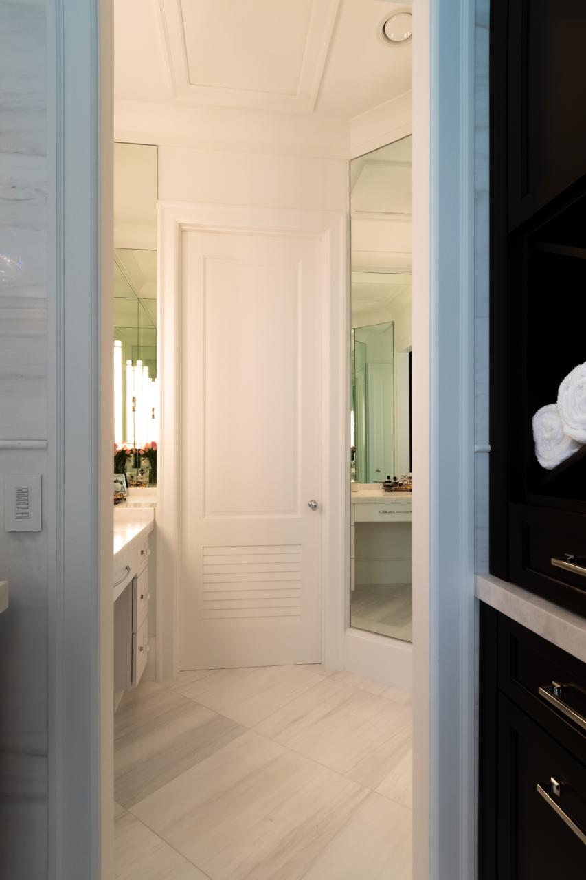 A master bath features TS2060 doors in MDF with Roman Ogee (OG) sticking, Raised (A) panel and Frosted Glass. The bottom panels have been replaced with false louver panels.