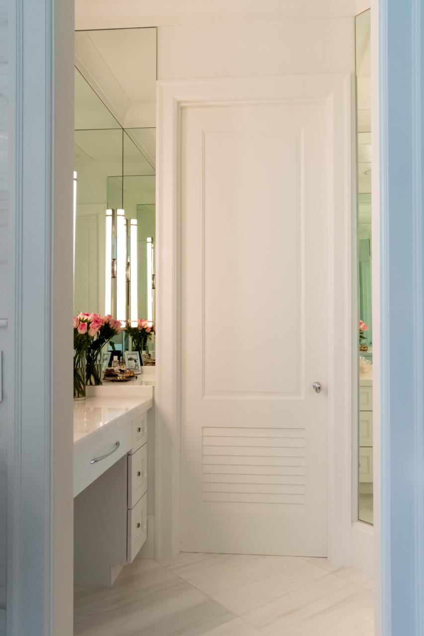 A master bath features TS2060 doors in MDF with Roman Ogee (OG) sticking, Raised (A) panel and Frosted Glass. The bottom panels have been replaced with false louver panels.