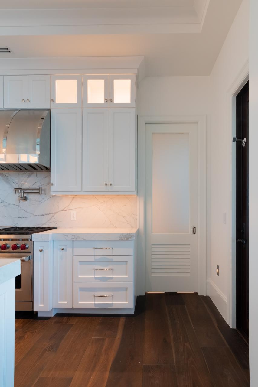 A TS2060 pantry door in MDF with Roman Ogee (OG) sticking, Raised (A) panel and Frosted Glass. The bottom panel has been replaced with false louver panel.