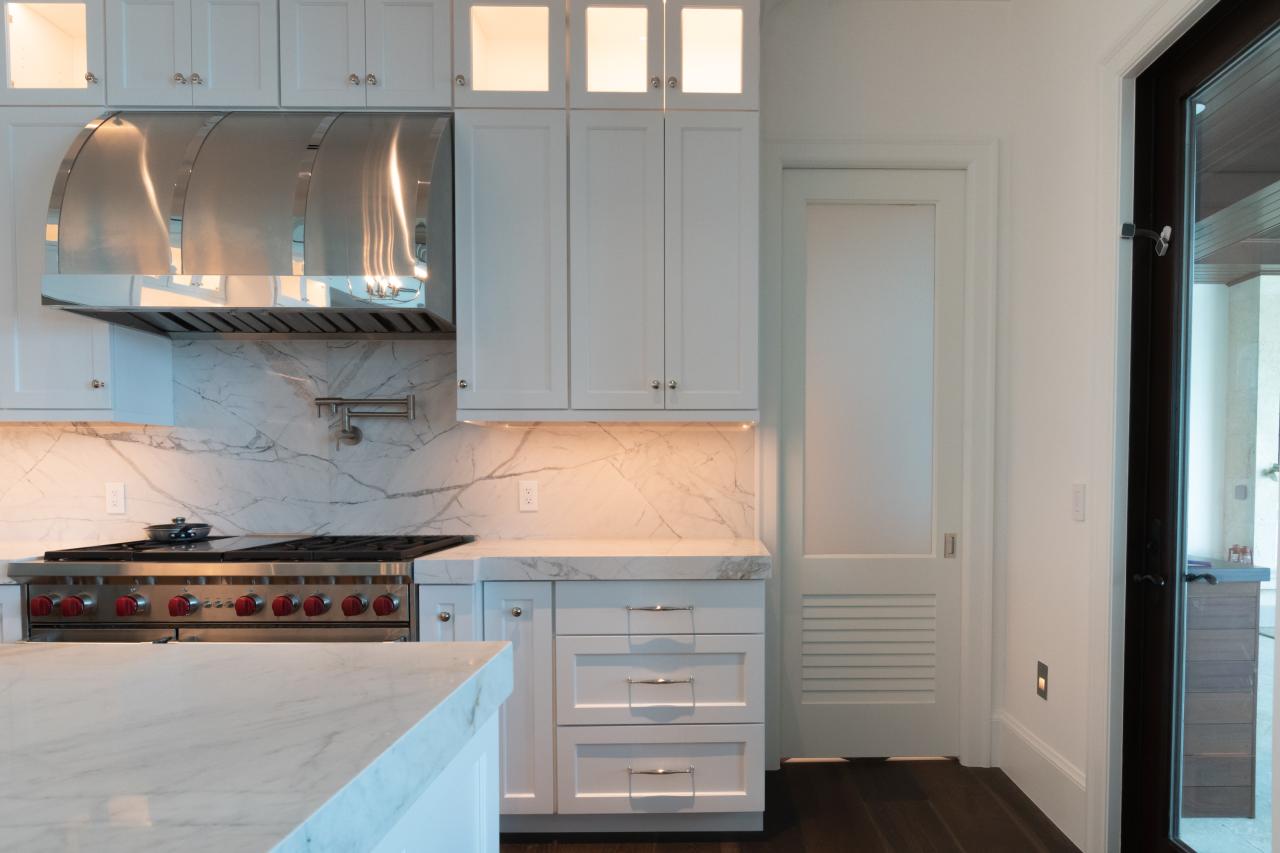 A TS2060 pantry door in MDF with Roman Ogee (OG) sticking, Raised (A) panel and Frosted Glass. The bottom panel has been replaced with false louver panel.