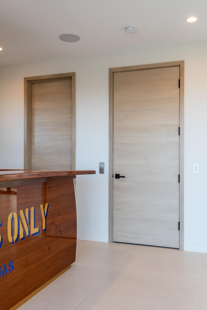 An upstairs lounge features TMF1000 flush doors in quarter sawn white oak with a custom ceruse finish.