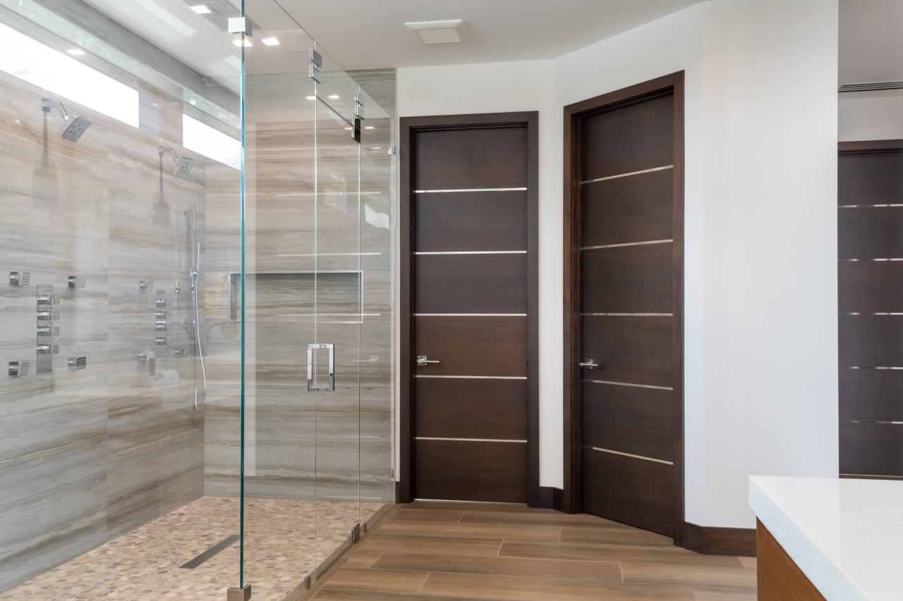 This master bath features TMIR6000 doors in mahogany with ½" bright stainless steel inlay. Builder provided stain finish.