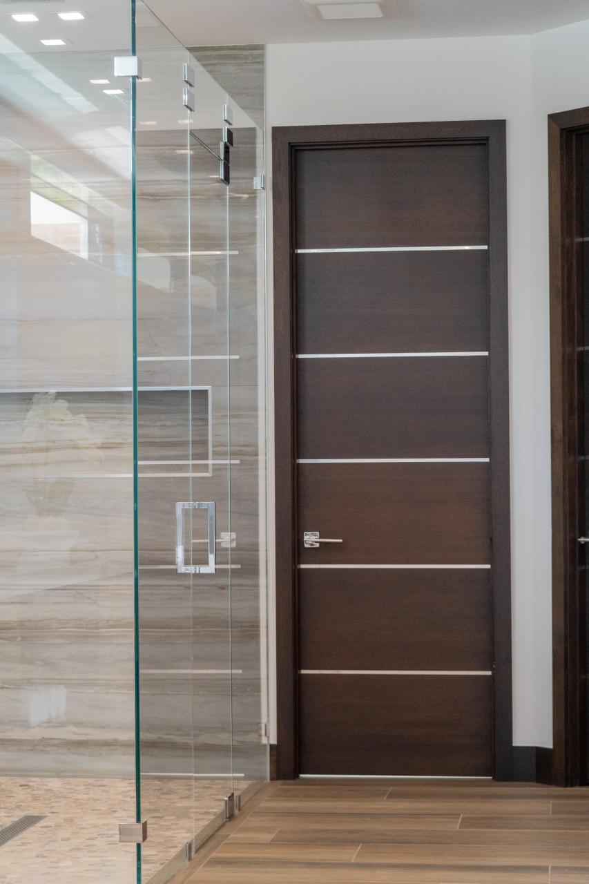 This master bath features TMIR6000 doors in mahogany with ½" bright stainless steel inlay. Builder provided stain finish.