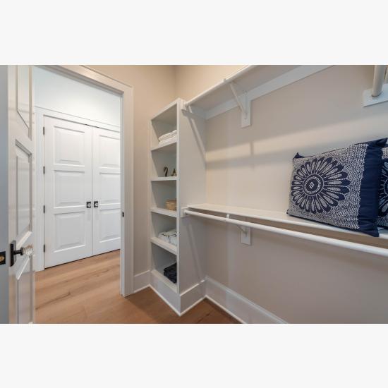 The heavy swing weight of these TS3000 doors, in MDF with Bevel (BV) sticking and Senior Bevel (F) panel, brings a feeling of quality to a walk-in closet.
