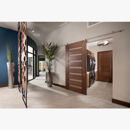 A TM9350 in walnut with Nutmeg stain and Bamboo Rings resin conceals the laundry room from the dining room. TM9000 in back.