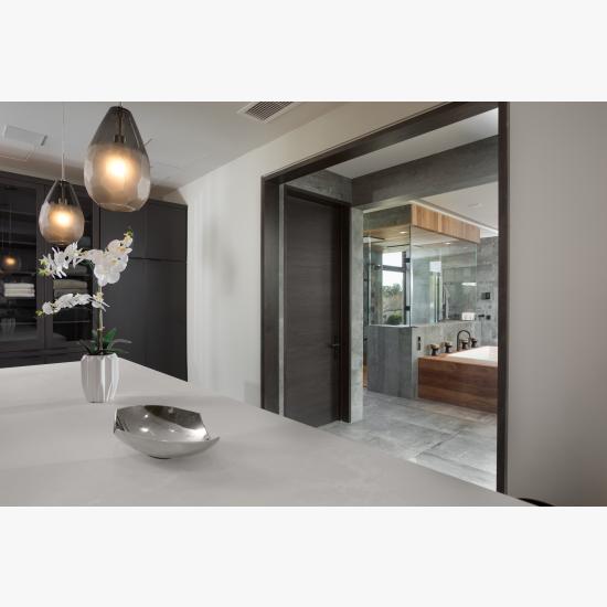 TMF1000 flush barn door, in walnut with Ebony stain, separated the master bath from a walk-in closet.