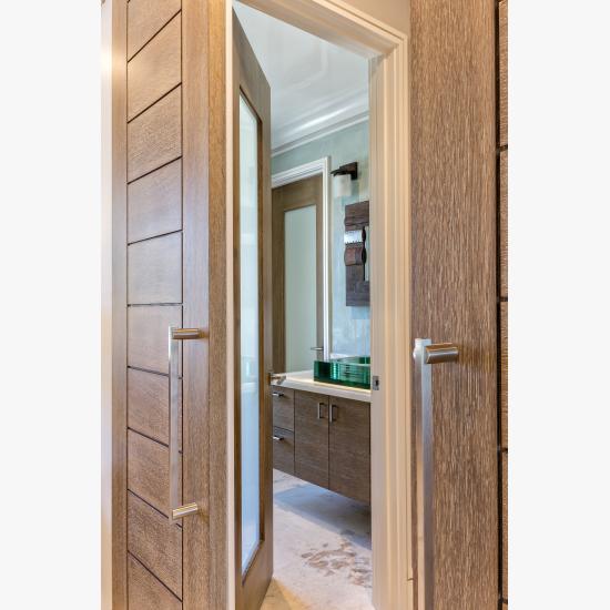 Pair of TM13000 barn doors in white oak with custom ceruse finish (TM1000 in background)