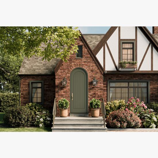 Radius top VG1040-ES401 Resilient Wood Entry System with vertical plank detailing and Multi-Point Lock hardware on a Tudor-inspired brick home.