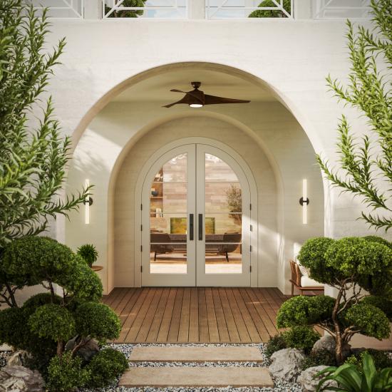 FL430-ES601 Resilient Wood Entry System with Bevel sticking and clear glass, featuring arched double doors in a contemporary stucco entryway with manicured landscaping.