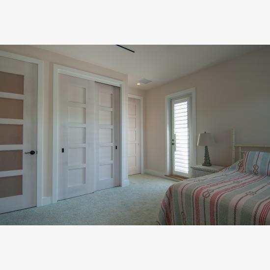 The custom whitewash finish of these birch TM5000 doors ties in with the pastel color scheme of the home.