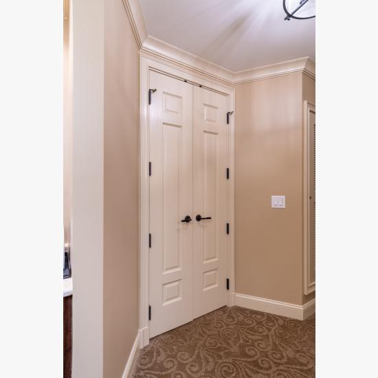 A pair of TS3100 doors in MDF with Roman Ogee sticking and Scoop (B) panel lead to the bathroom suite.