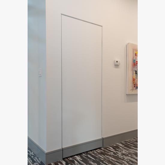 Concealed hinges and jamb allow this TMF1000 closet door in MDF to blend into the wall.