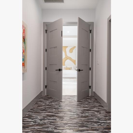 A pair of TM9420 doors in MDF open to the master bedroom.