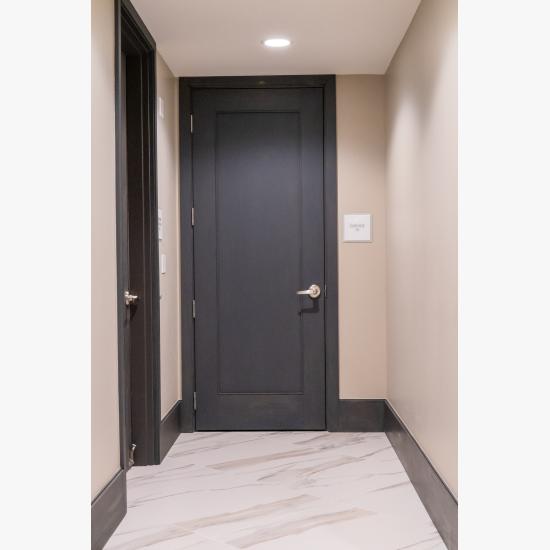Condominium tower featuring TS1000 doors, in rift sawn white oak with Quirk (QM) moulding and Flat (C) panel in lobby.