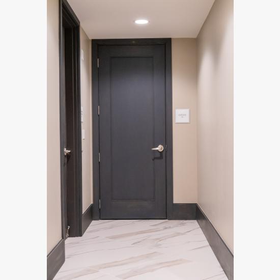 Condominium tower featuring TS1000 doors, in rift sawn white oak with Quirk (QM) moulding and Flat (C) panel in lobby.