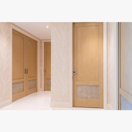 This master bedroom suite features modified TS2210 doors in wire-brushed plain sawn white oak with customer-applied ceruse finish and Shagree Grey Oyster leather.