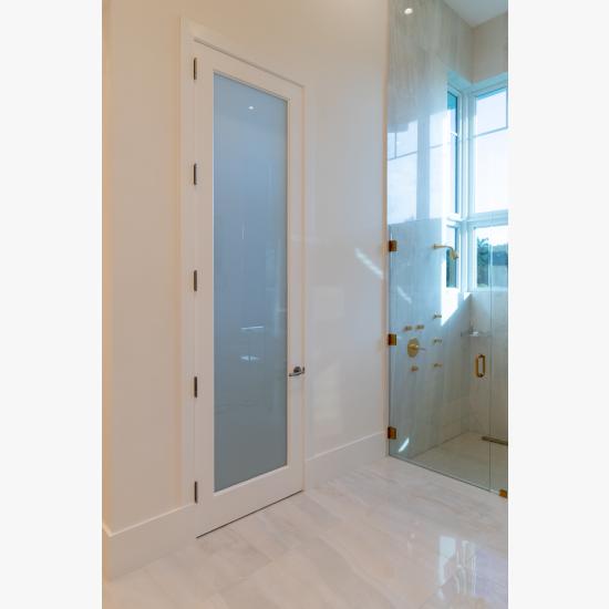 This master bath features 10' tall TS1000 door in MDF with One Step sticking and White Lami glass