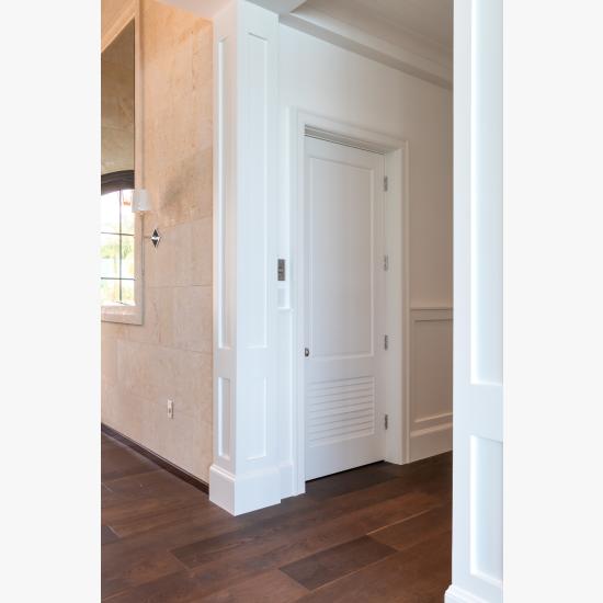 The elevator on this coastal home features a TS2060 in MDF with Roman Ogee (OG) sticking and Raised (A) panel. The bottom panel has been switched to a false louver panel.