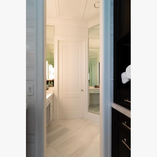A master bath features TS2060 doors in MDF with Roman Ogee (OG) sticking, Raised (A) panel and Frosted Glass. The bottom panels have been replaced with false louver panels.