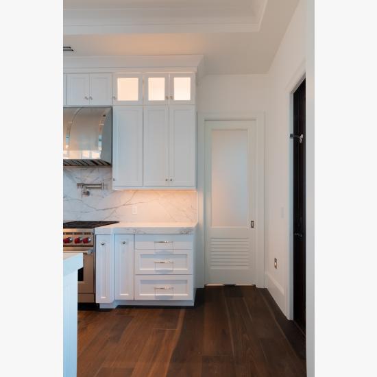 A TS2060 pantry door in MDF with Roman Ogee (OG) sticking, Raised (A) panel and Frosted Glass. The bottom panel has been replaced with false louver panel.