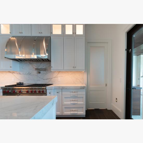 A TS2060 pantry door in MDF with Roman Ogee (OG) sticking, Raised (A) panel and Frosted Glass. The bottom panel has been replaced with false louver panel.