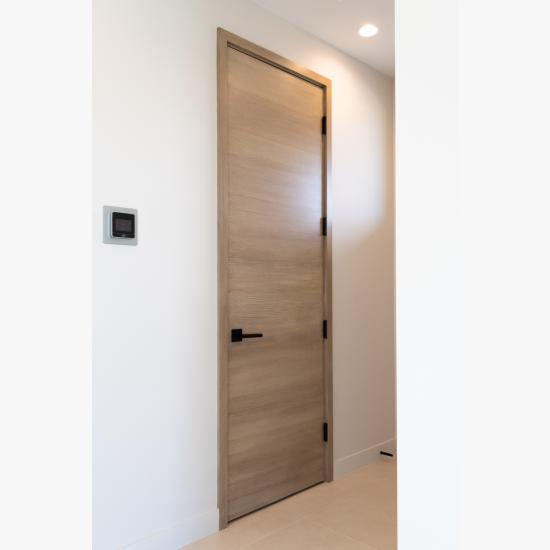 An upstairs lounge features TMF1000 flush doors in quarter sawn white oak with a custom ceruse finish.