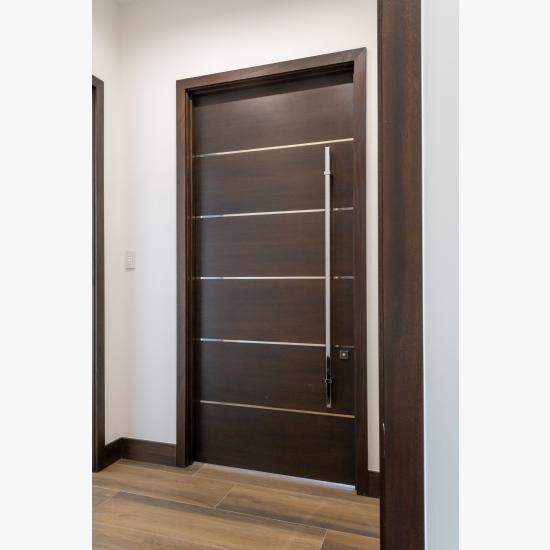 TMIR6000 doors in mahogany with ½" bright stainless steel inlays. Customer stained finish.