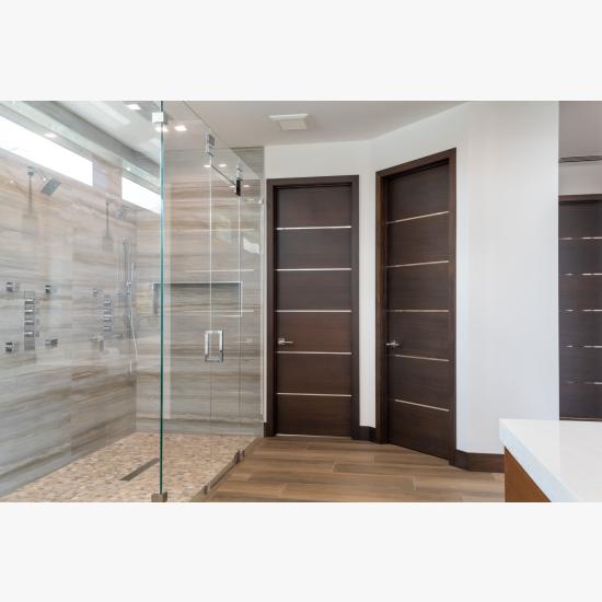 This master bath features TMIR6000 doors in mahogany with ½" bright stainless steel inlay. Builder provided stain finish.