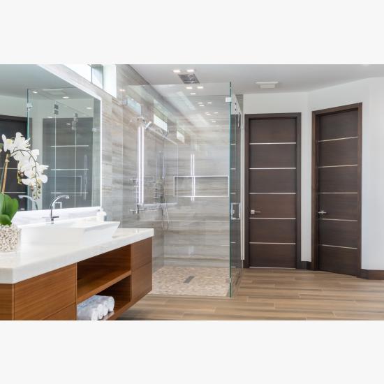 This master bath features TMIR6000 doors in mahogany with ½" bright stainless steel inlay. Builder provided stain finish.