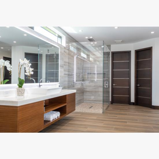 This master bath features TMIR6000 doors in mahogany with ½" bright stainless steel inlay. Builder provided stain finish.