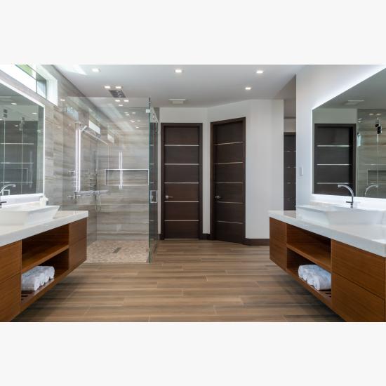 This master bath features TMIR6000 doors in mahogany with ½" bright stainless steel inlay. Builder provided stain finish.