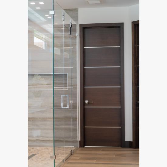 This master bath features TMIR6000 doors in mahogany with ½" bright stainless steel inlay. Builder provided stain finish.