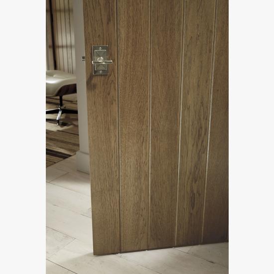 Detail of hickory plank door (VG1000) with wide V-groove profile and Cappuccino handwiped stain