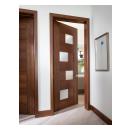 This guest room features a TM9430 door, in walnut with Nutmeg stain and Flow glass, that opens to an adjacent bathroom